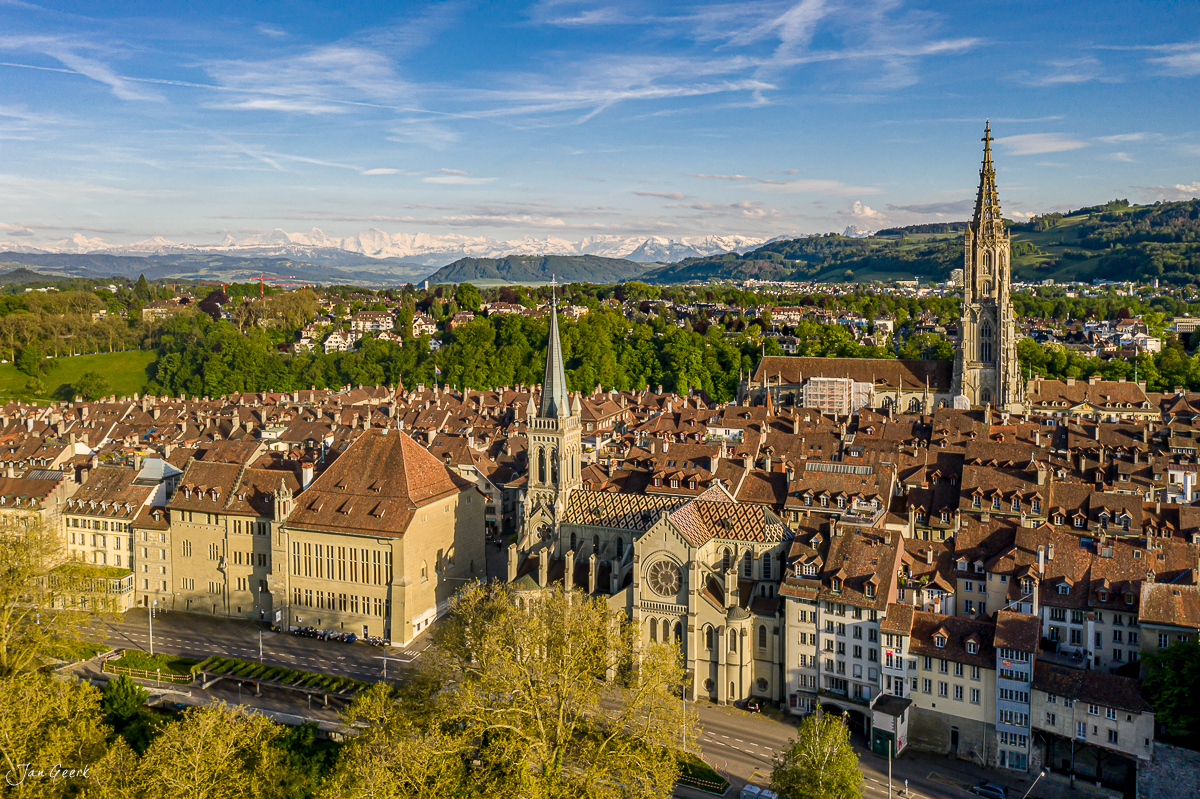 Luftaufnahme der Berner Altstadt mit Münster im Frühling, Alpenblick, Schweiz – Jan Geerk Fotograf Basel