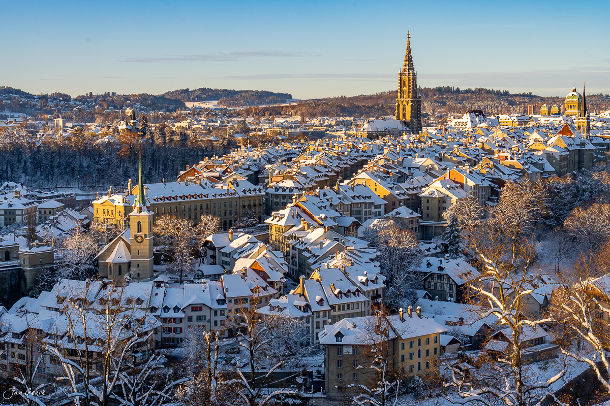 Wintermorgen in Bern Altstadt mit verschneiten Dächern, Münster und Rosengarten, goldenes Kantenlicht – Jan Geerk Fotograf Basel Schweiz