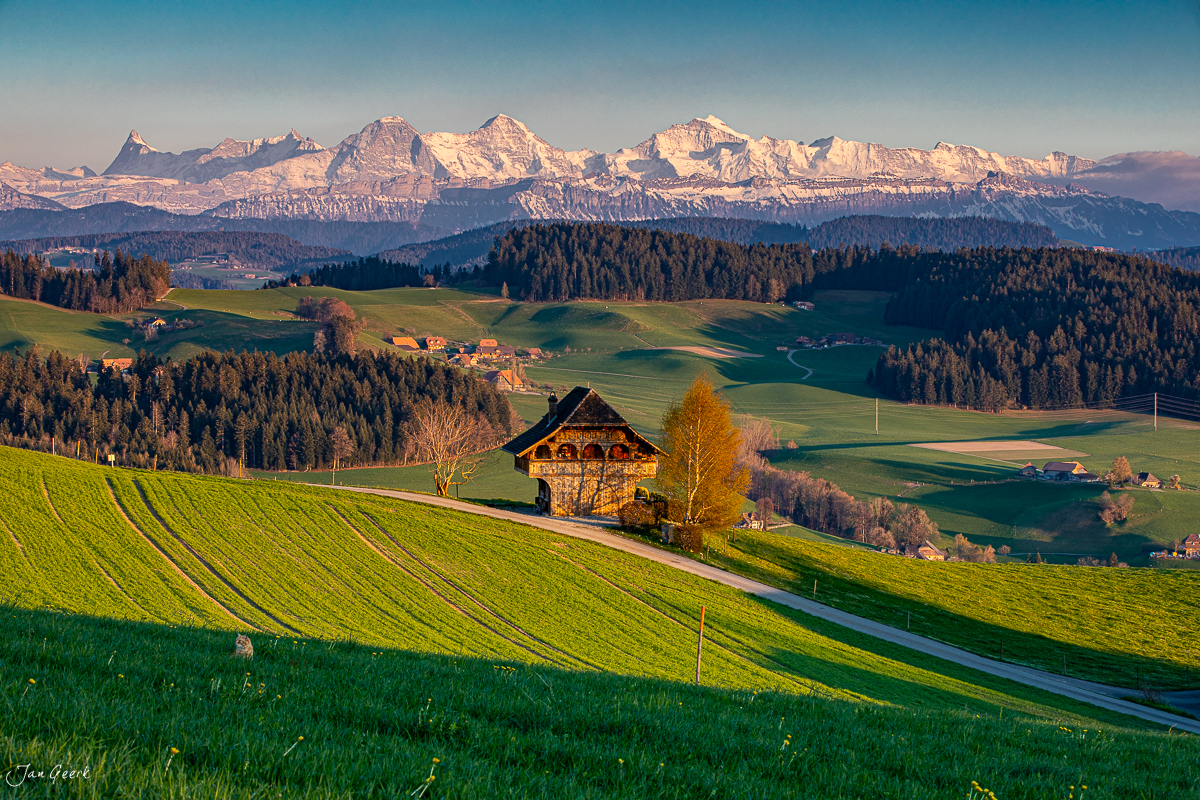 Traditioneller Spycher in Biglen mit Alpenpanorama im Frühling, Emmental Berner Oberland Schweiz – Jan Geerk Fotograf Basel