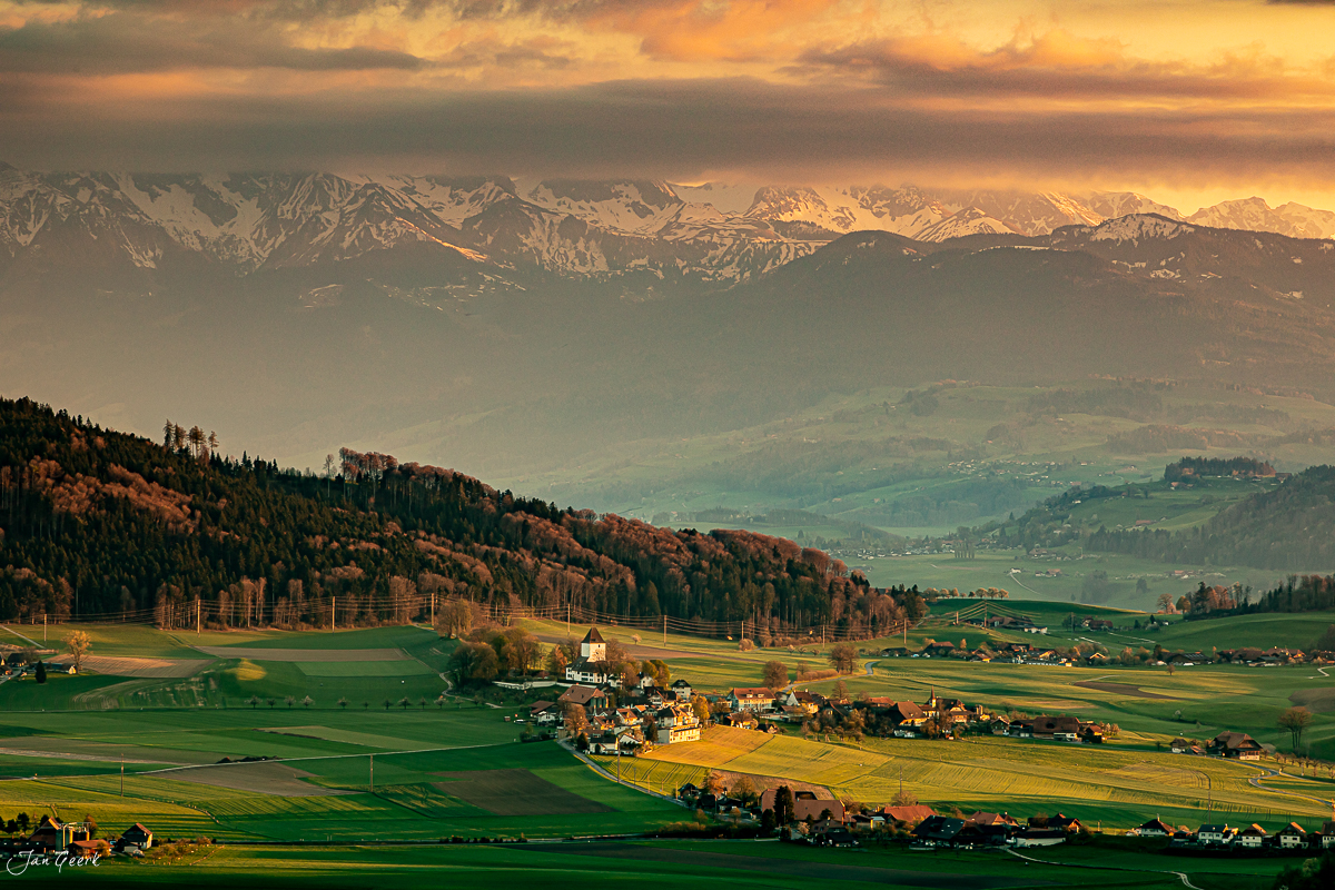 Blick auf Biglen mit Alpenkette im goldenen Frühlingslicht, Emmental Berner Oberland Schweiz Jan Geerk Fotograf Basel