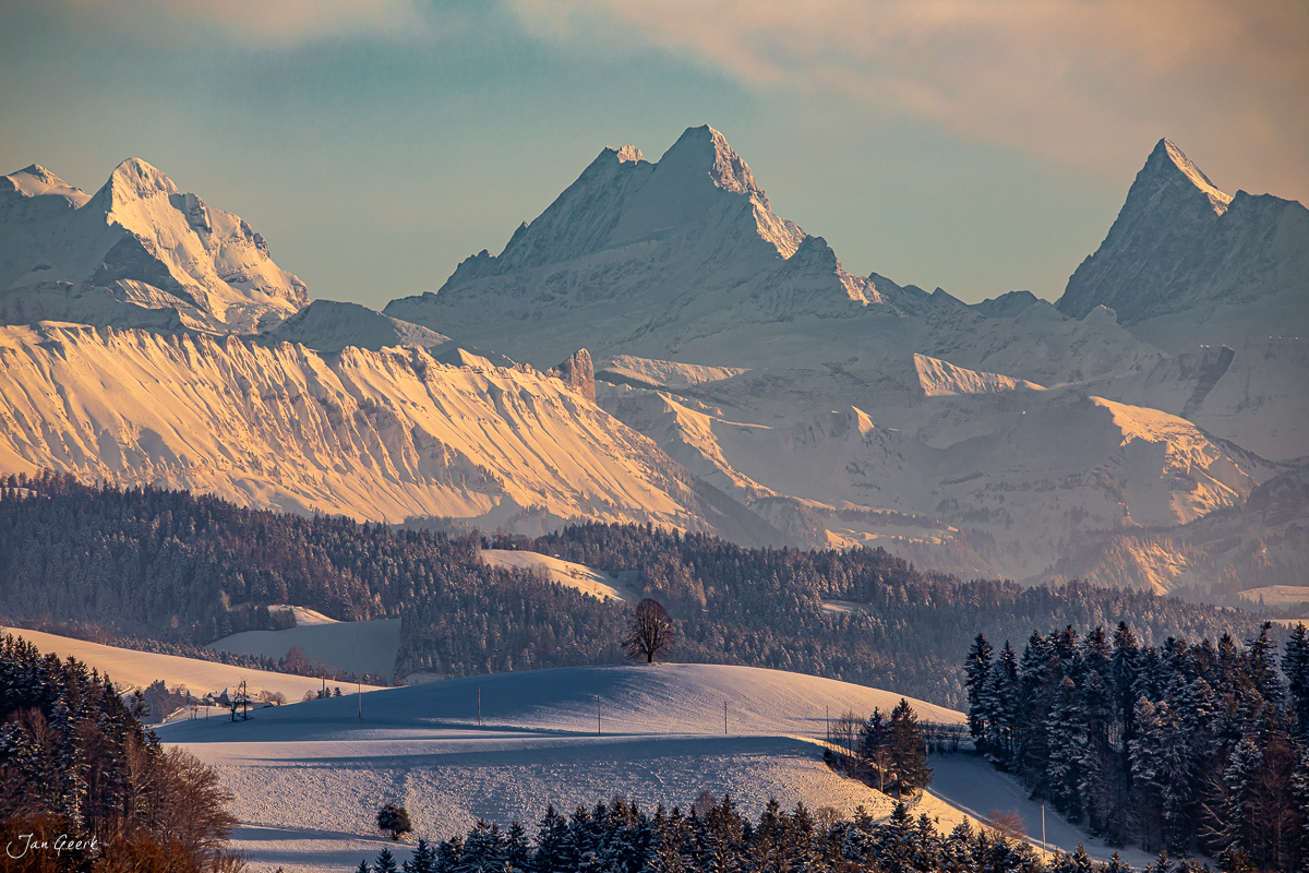 Winterlandschaft Emmental mit schneebedeckten Alpengipfeln bei Kantlicht, Berner Oberland Schweiz – Jan Geerk Fotograf Basel