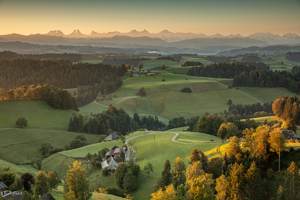 Herbstliche Alpensicht über das Emmental mit grünen Hügeln und Bauernhöfen Schweiz Jan Geerk Fotograf Basel