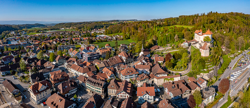 Luftaufnahme der Altstadt Laupen mit Schloss und roten Dächern im Frühling, Berner Oberland Schweiz – Jan Geerk Fotograf Basel