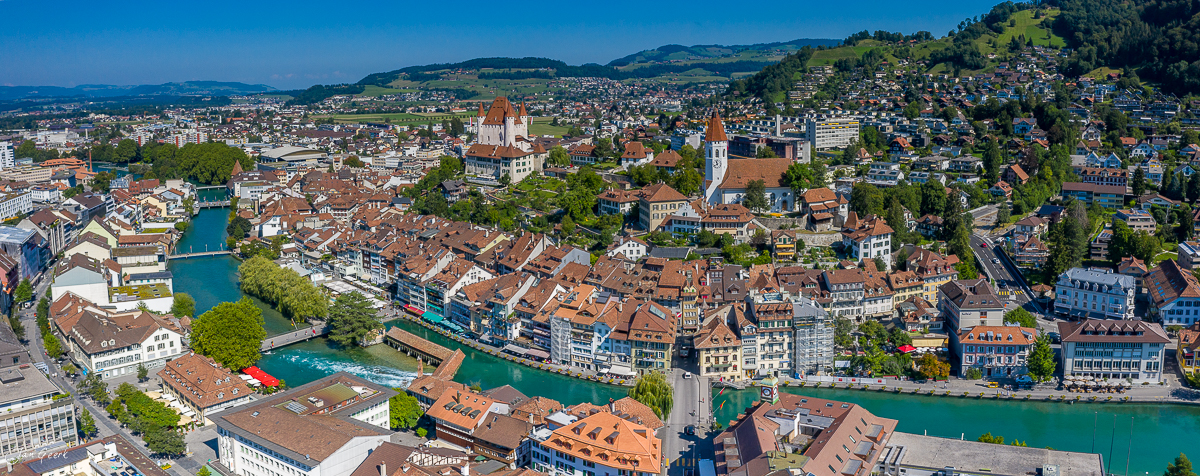 Luftaufnahme Thun mit Schloss und Aare Fluss Sommerlicht Berner Oberland Schweiz Jan Geerk Fotograf Basel