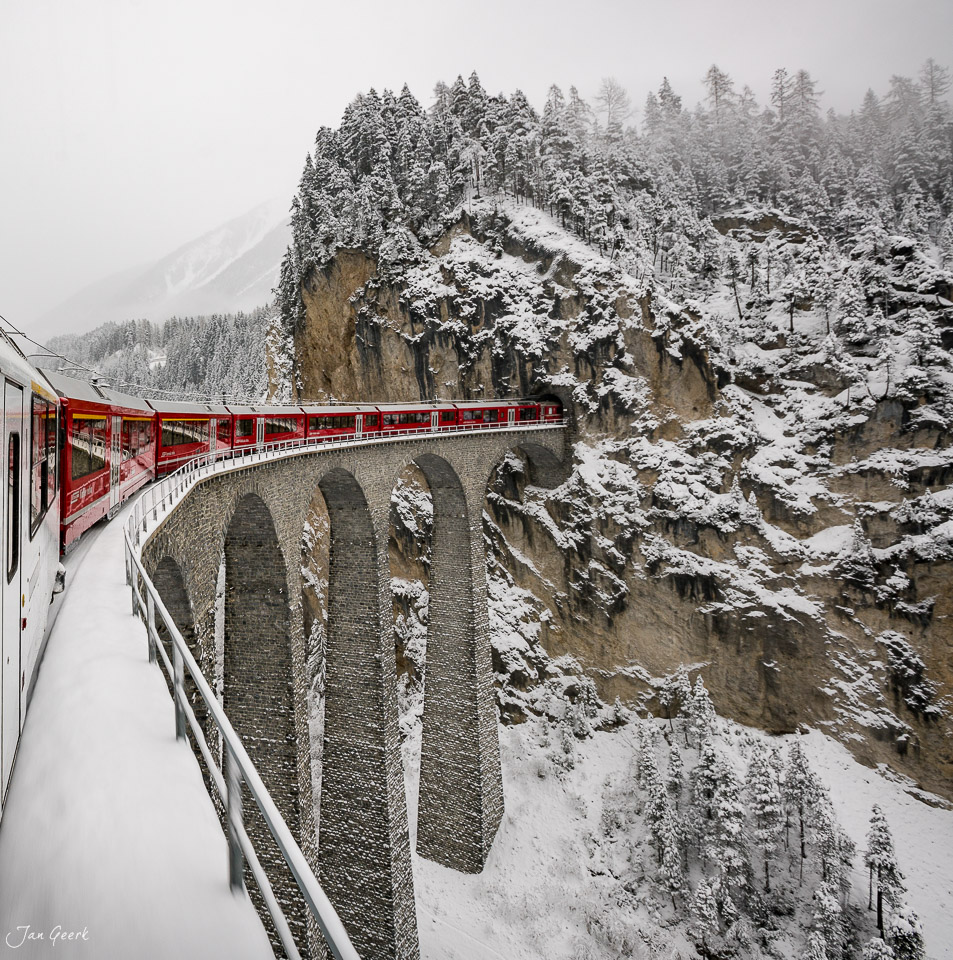 Landwasserviadukt im Schnee mit rotem Zug Winter Graubünden Schweiz Jan Geerk Fotograf Basel