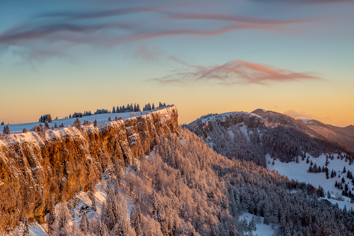 Schneebedeckte Felswand und Bergwald bei Sonnenaufgang am Grenchenberg, Jura, Schweiz – Jan Geerk Fotograf Basel