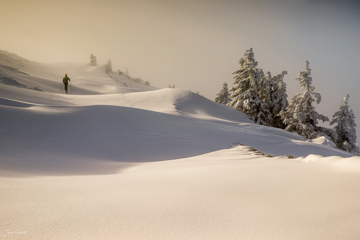 Schneeschuhwanderer in der Winterlandschaft La Dole Jura bei verschneiten Fichten Schweiz Jan Geerk Fotograf Basel