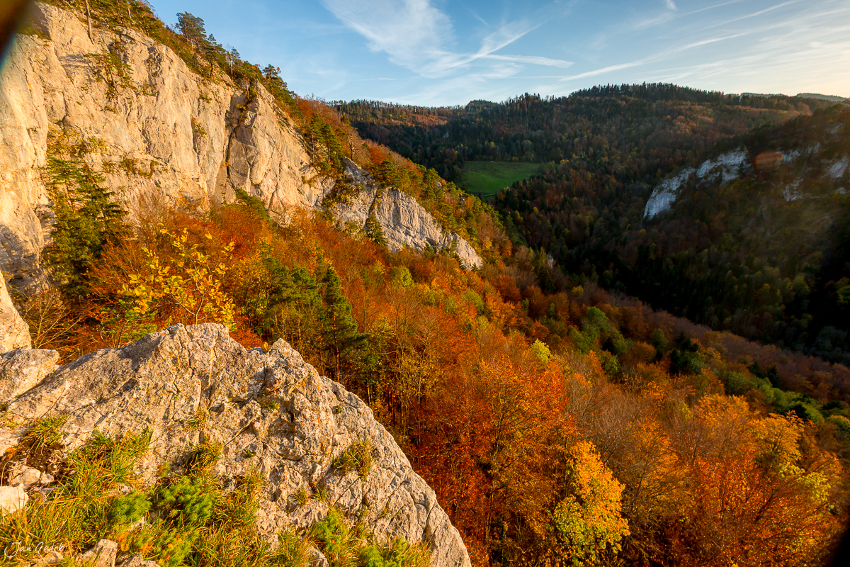 Felsige Klippe mit Herbstwald im Jura bei Dornach, golden beleuchtete Landschaft, Schweiz – Jan Geerk Fotograf Basel
