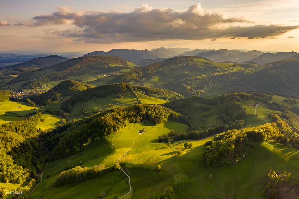 Luftaufnahme Belchen Frühjahrslandschaft grüne Hügel Wald Baselland Schweiz Jan Geerk Fotograf Basel