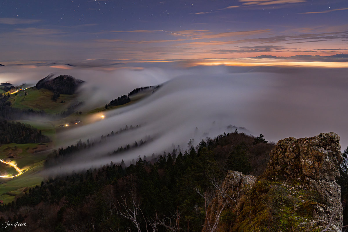 Nebelwelle über dem Belchen im Winter mit Sternenlichtern und Berglichtern in der Schweiz – Jan Geerk Fotograf Basel