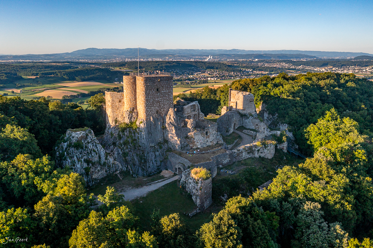 Luftaufnahme der Ruine Landskron auf Felsen umgeben von grünem Wald, Herbststimmung, Nordwestschweiz – Jan Geerk Fotograf Basel