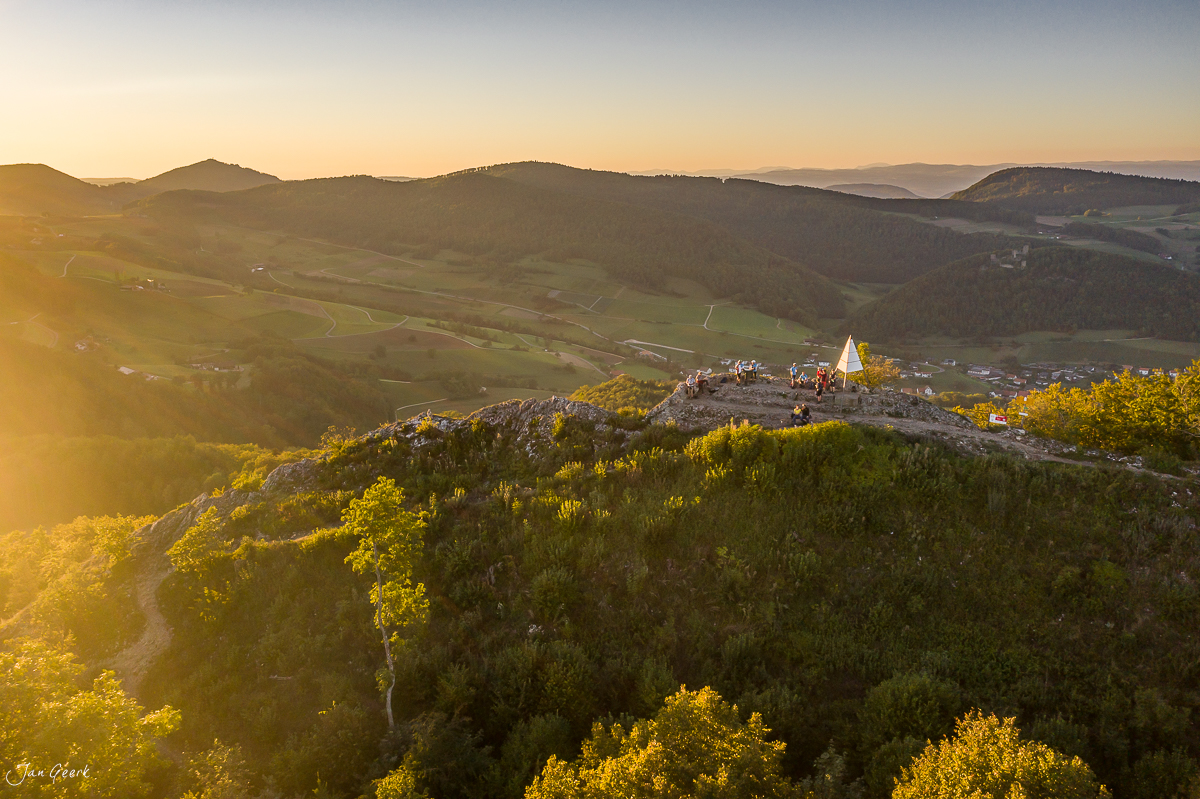 Drohnenaufnahme der Gislifluh mit Kapelle im Sonnenuntergang, bewaldete Hügel und Aargauer Landschaft, Schweiz – Jan Geerk Fotograf Basel