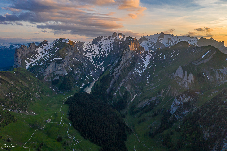Alpstein Massiv mit schneebedeckten Gipfeln, grünen Alpweiden und Tal bei Sonnenuntergang Appenzell Alpen Schweiz Jan Geerk Fotograf Basel