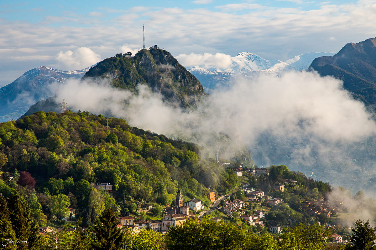 Bergdorf mit Kirche und schneebedeckten Alpen im Hintergrund, Sommerlandschaft in Beromünster, Schweiz – Jan Geerk Fotograf Basel