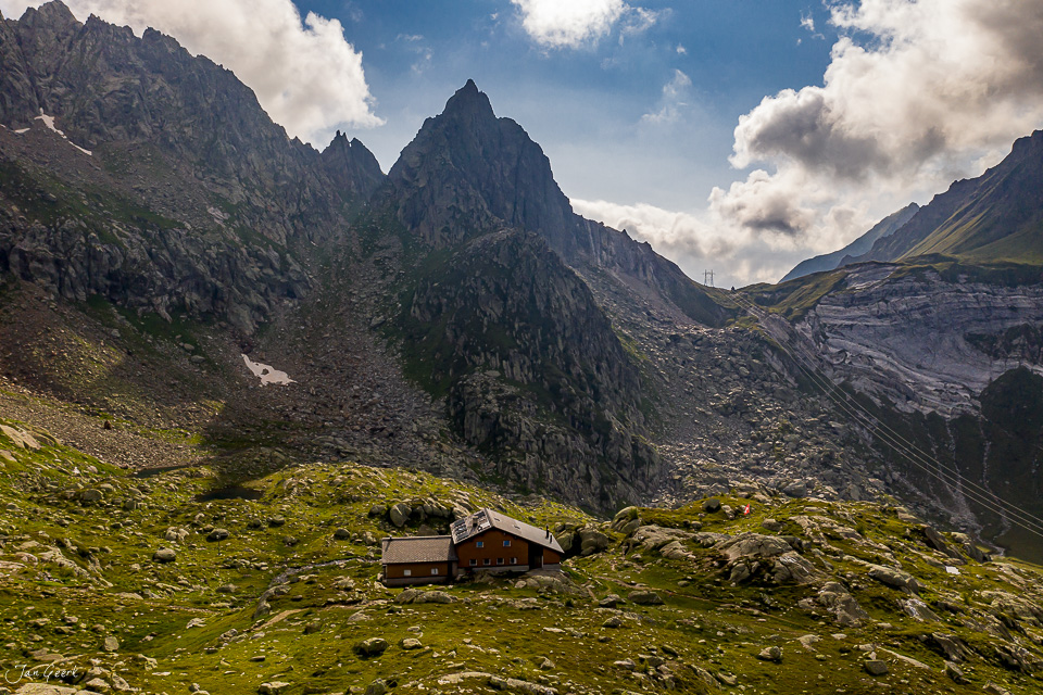 Berghütte in alpiner Berglandschaft mit Felsgipfeln im Tessin, sommerliche Luftaufnahme Schweiz – Jan Geerk Fotograf Basel