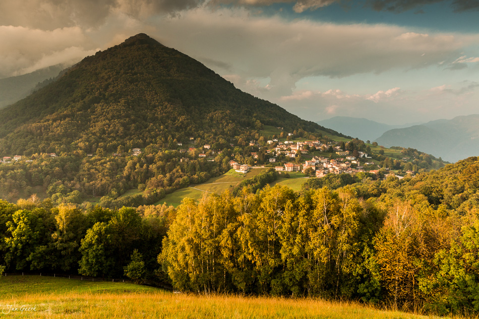 Berghang mit Dorf und Herbstwald in Ascona, Tessin, goldenes Herbstlicht, Schweiz – Jan Geerk Fotograf Basel