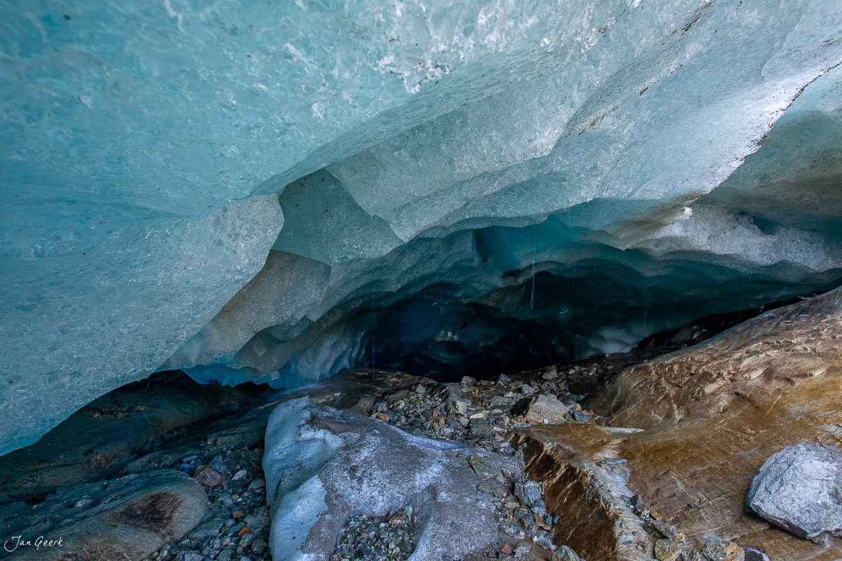 Gletscherhöhle im Aletschgletscher mit türkisblauem Eis und Felsformation, Herbststimmung im Wallis, Schweiz – Jan Geerk Fotograf Basel
