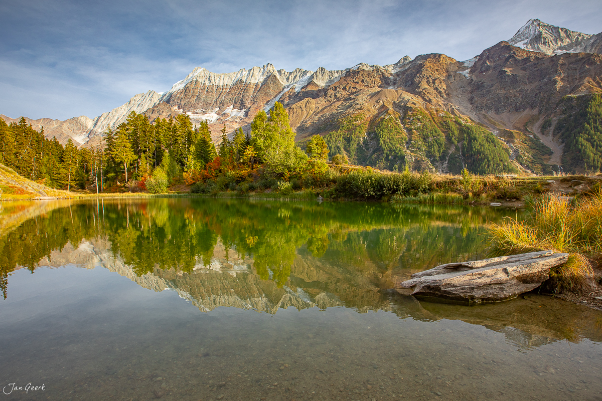 Bergsee mit Spiegelung der schneebedeckten Berggipfel im Lötschental Wallis Schweiz – Jan Geerk Fotograf Basel