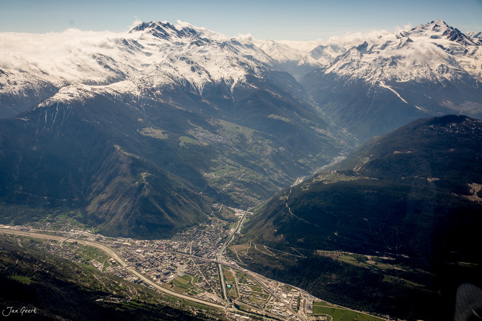 Luftaufnahme Rhonetal mit verschneiten Berner Oberland Gipfeln, grüne Täler und Fluss, Helikopterflug Schweiz – Jan Geerk Fotograf Basel