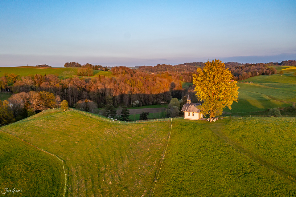 Herbstliche Kapelle in grüner Landschaft mit goldenem Laubbaum, Mühletal, Westschweiz – Jan Geerk Fotograf Basel