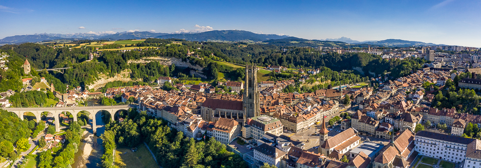Luftaufnahme der Altstadt Fribourg mit Kathedrale Saint-Nicolas, Saane-Fluss und Viadukt, Sommerlicht, Westschweiz – Jan Geerk Fotograf Basel