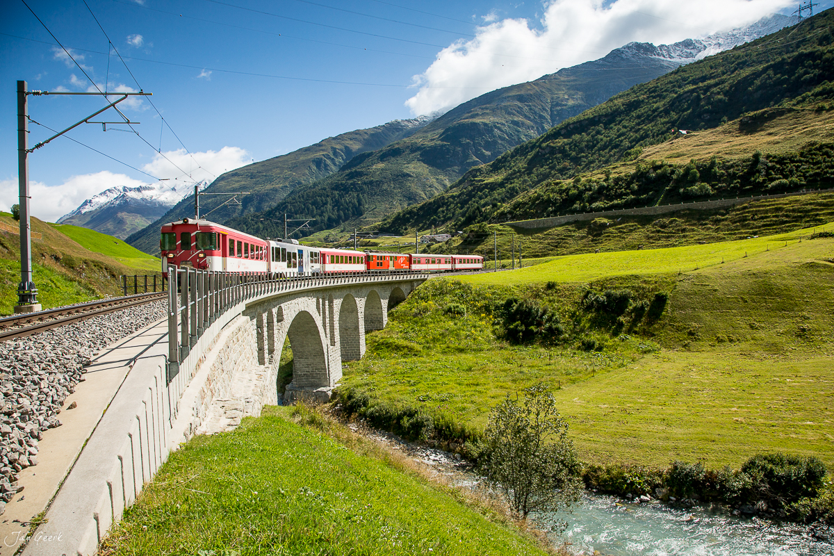 Rote Zahnradbahn auf Viadukt in alpiner Berglandschaft, Locarno Sommer Tessin Schweiz – Jan Geerk Fotograf Basel