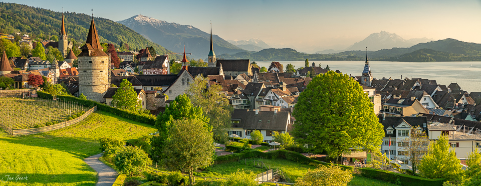 Zug Altstadt mit Kirchtürmen und Zugersee, grüne Wiesen, Frühlingslicht, Zentralschweiz – Jan Geerk Fotograf Basel
