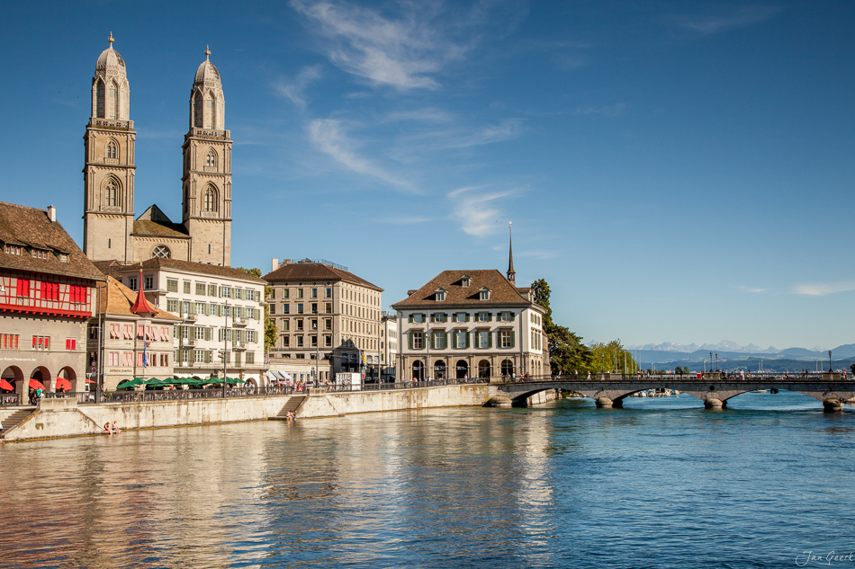 Zürich Altstadt mit Grossmünster am Limmatufer, Sommerblick auf Berge und See, Schweiz – Jan Geerk Fotograf Basel